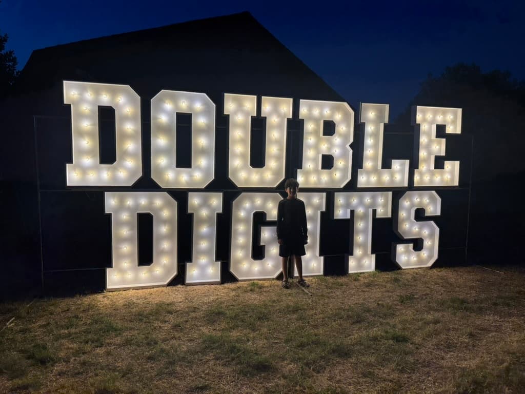 Double digits marquee letters with a child at a 10th birthday party